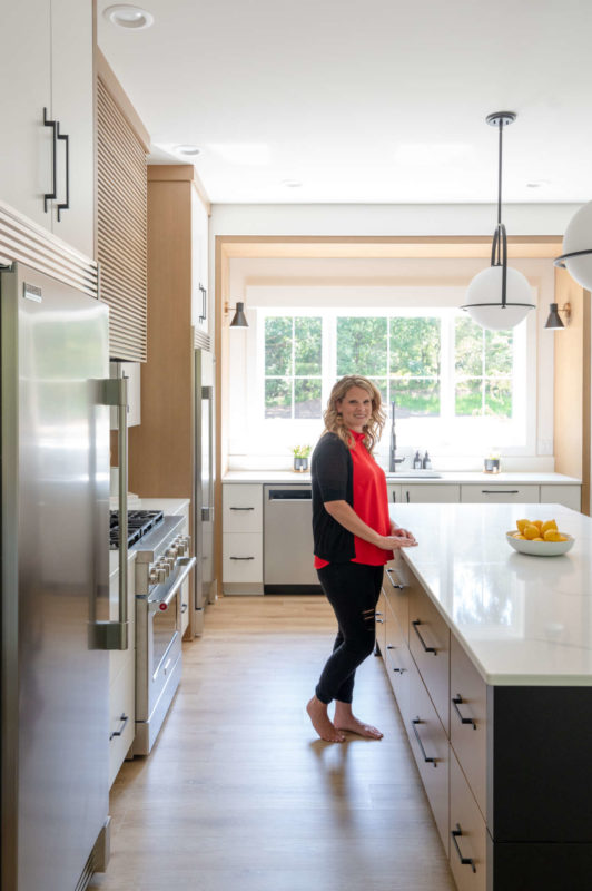 woman standing in remodeled kitchen design